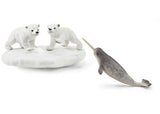 Two playful polar bears on an icy fortress with a narwhal nearby, featured in the Schleich Polar Playground playset.