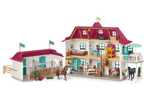 Playful Schleich Lakeside Country House and Stable set, featuring a country house, stable, and accessories for imaginative adventures.