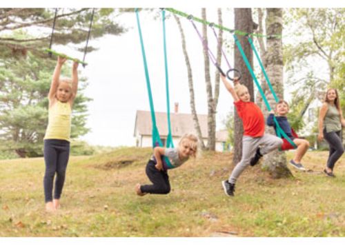 Colorful Slackers Swingline 36-foot Ninjaline with soft swings, ninja rings, and safety sleeves for kids' outdoor fun.