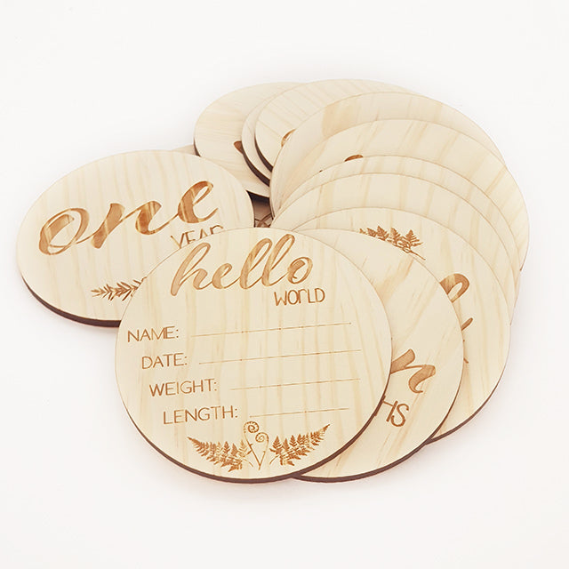 Milestone Discs Set featuring 14 engraved NZ floral designs on 10cm pine veneer discs for capturing baby growth memories.