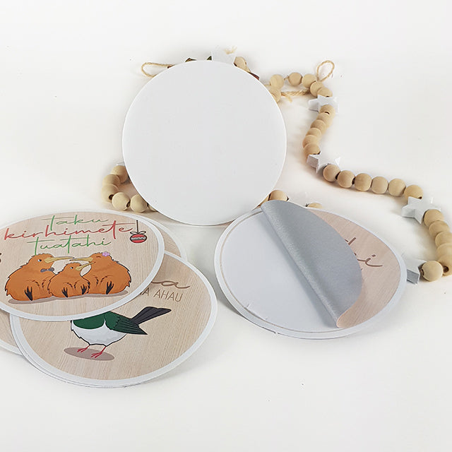 Milestone disc set featuring vibrant NZ bird designs for documenting baby's first year, made from eco-friendly fabric.