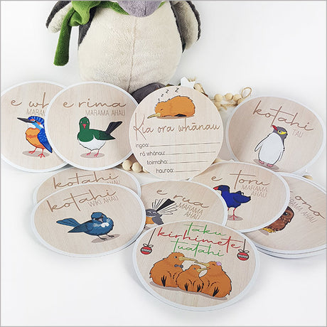 Colorful milestone discs featuring NZ native birds for capturing baby's first year in photos, designed with eco-friendly fabric.