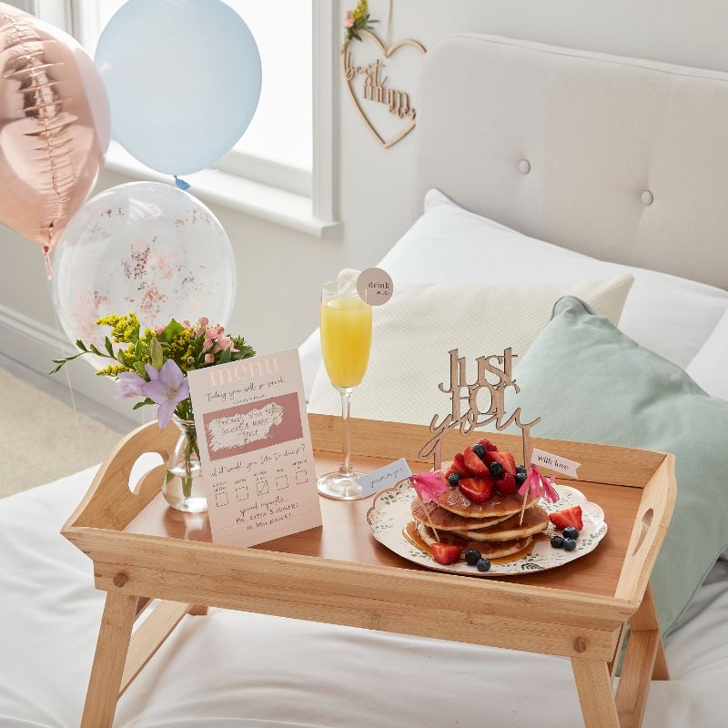 Customisable Breakfast in Bed Set featuring a scratch-to-reveal menu, drink topper, cake topper, cupcake toppers, and balloons.
