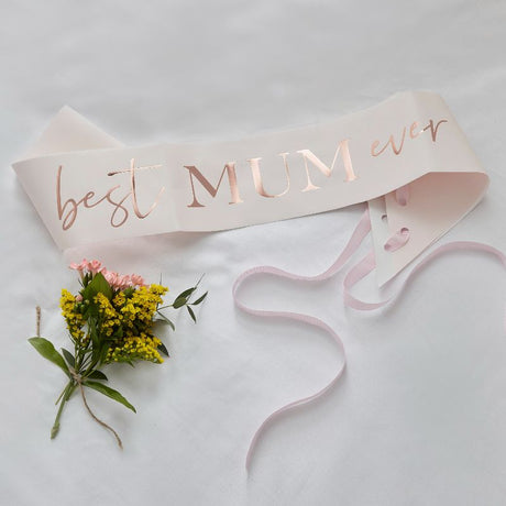 Blush pink sash with shimmering rose gold "Best Mum Ever" script, perfect for celebrating Mother's Day memories.