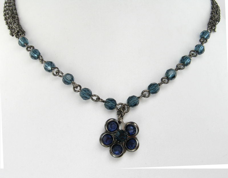 Multi-chain necklace with a blue crystal petal, perfect for adding glamour to any outfit or occasion.