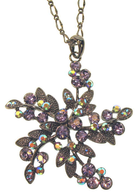 Elegant snowflake pendant necklace featuring tanzanite and AB Amethyst, on an 18-inch gun color chain with extension.