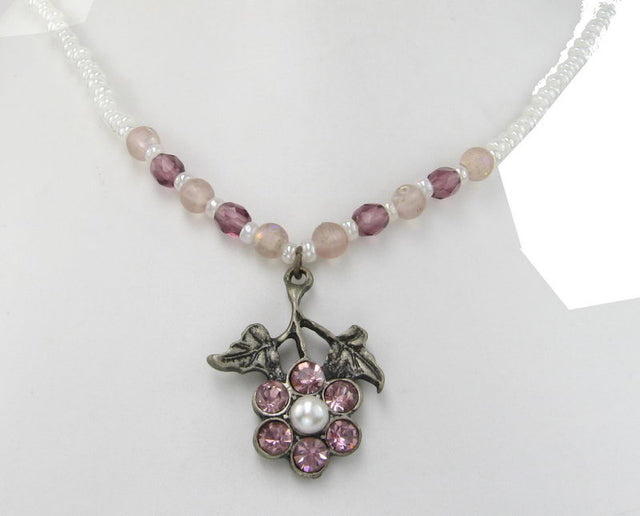 Elegant necklace showcasing pink diamante drops on beads, perfect for casual or glamorous occasions.