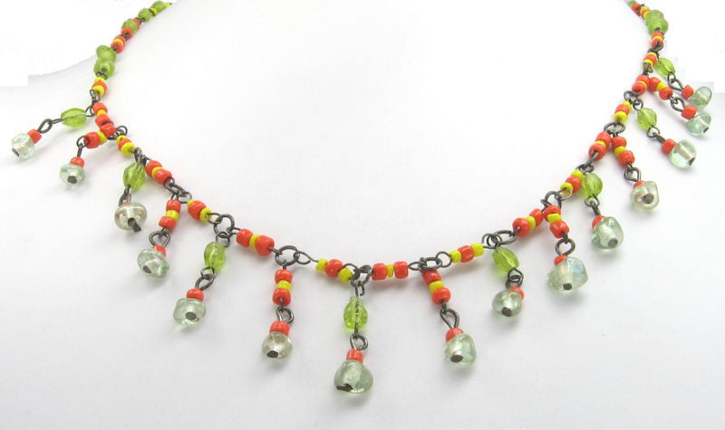 Vibrant yellow and orange necklace with lively green beads, perfect for adding color and style to any outfit.