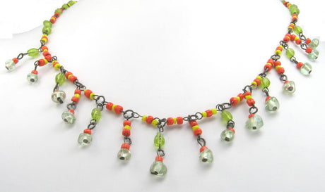 Vibrant yellow and orange necklace with lively green beads, perfect for adding color and style to any outfit.