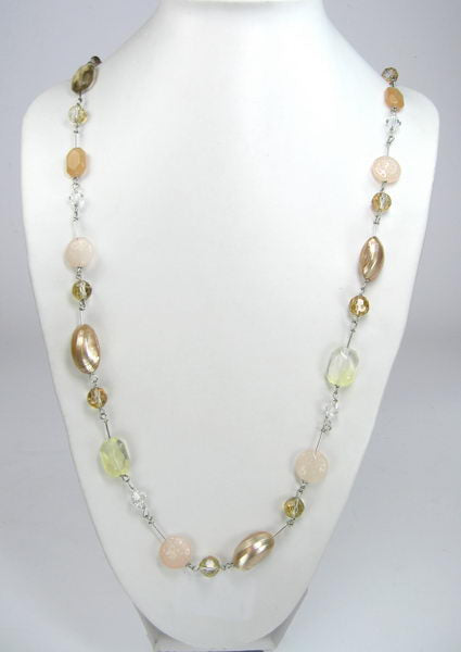 Handmade necklace featuring a shell pendant adorned with vibrant earth-toned gemstones, perfect for nature lovers.