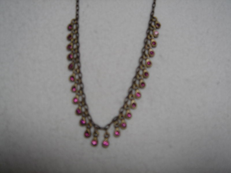 Handcrafted pink brass chain necklace with dazzling drop accents, perfect for elevating any outfit.