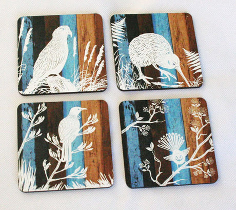 Set of four coasters featuring unique designs of New Zealand native birds, crafted from durable MDF for stylish decor.