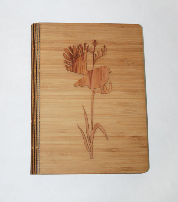 Elegant notebook featuring a fantail on tall flax design, crafted from NZ Silver Beech and Bamboo Veneer, 165 x 225 mm.