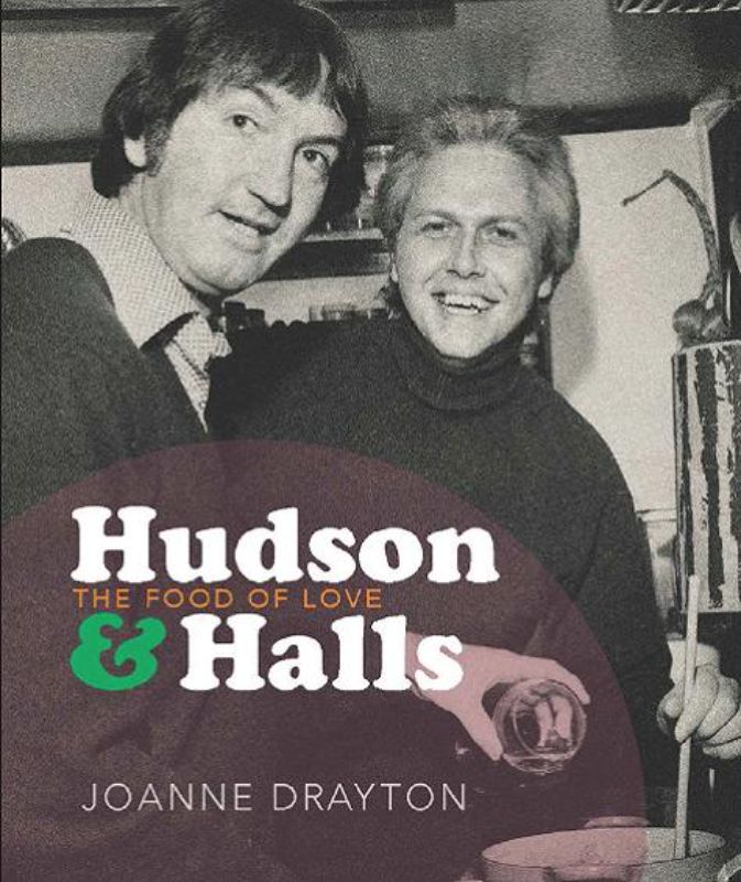 Paperback book titled "The Food of Love," showcasing the revolutionary chefs Hudson & Halls and their impact on cooking and LGBTQ+ representation.