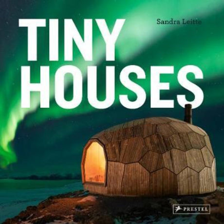 A hardback book featuring stunning tiny houses, showcasing innovative design and sustainable living solutions in beautiful photos.