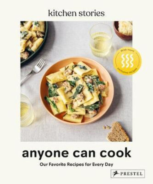 Hardcover cookbook "Anyone Can Cook" by Kitchen Stories, featuring 320 pages of easy, elegant recipes for all skill levels.