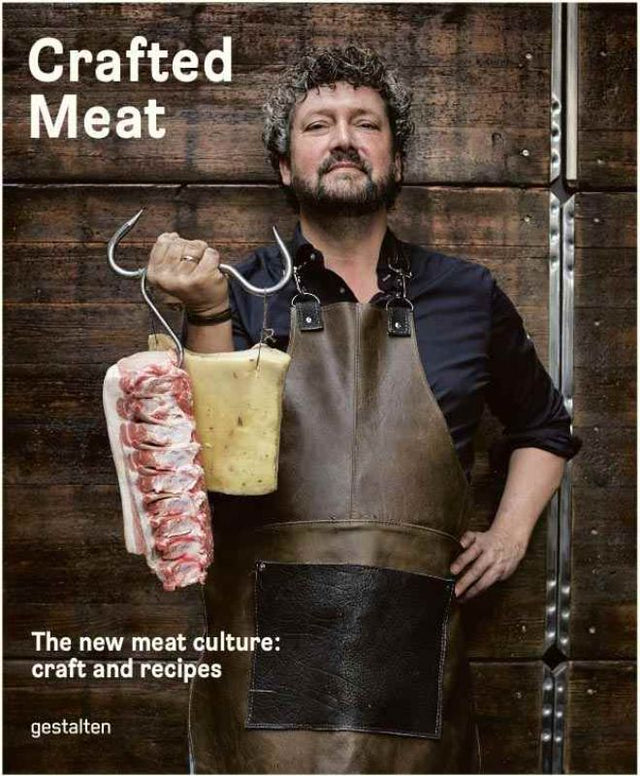A hardback book titled "Crafted Meat," featuring recipes and tips for artisanal charcuterie and gourmet meat preparation.