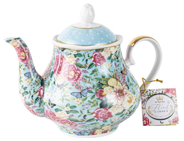 Elegant powder blue teapot with a floral garden pattern, ideal for serving tea and enhancing any dining decor.