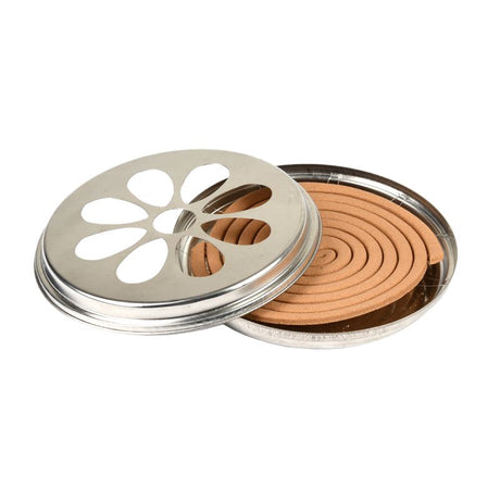 Citronella coils in a zinc burner with metal holder, offering natural insect repellent for outdoor spaces, 14 x 14 x 3cm.