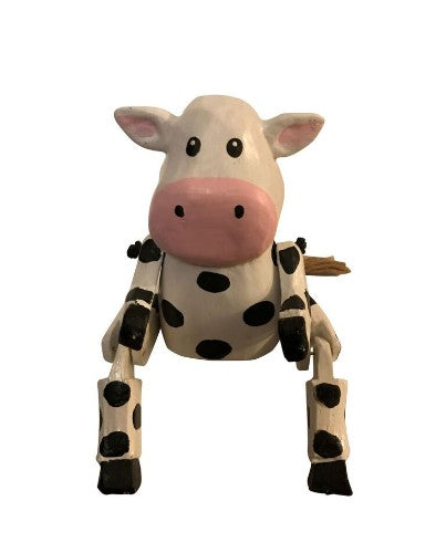 Small wooden cow ornament with dangling legs, adding rustic charm and playful movement to your home decor.