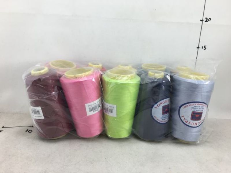 Set of 10 vibrant sewing threads in assorted colors, ideal for quilting, crafting, and mending projects.