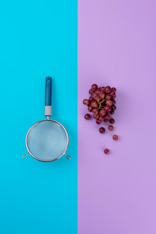 Tasty Mesh Strainer in vibrant blue, crafted from stainless steel for straining, rinsing, and sifting with precision.