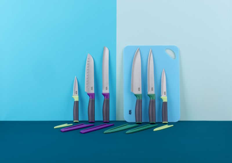 Tasty Chef's Knife Set featuring 6 essential knives with vibrant sleeves, designed for comfort, durability, and easy cleaning.