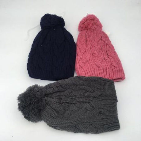 Colorful set of 12 assorted beanies with fluffy pom poms, perfect for adding warmth and style to winter outfits.
