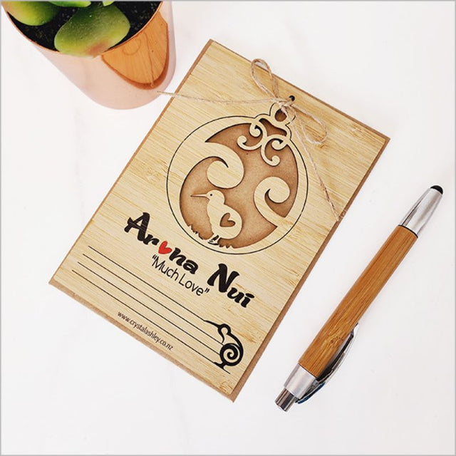 Eco-friendly bamboo postcard with Kiwi design, featuring Aroha Nui, jute string, and craft envelope. Ideal for heartfelt messages.