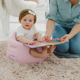 Bumbo Floor Seat in Cradle Pink, designed for infants 3-12 months, promotes safe sitting with deep seating and curved backrest.
