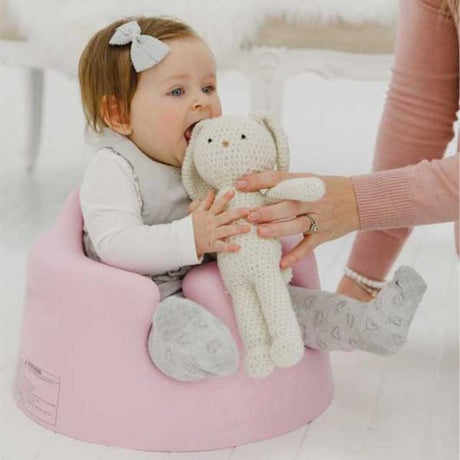 Bumbo Floor Seat in Cradle Pink, safely supports infants 3-12 months for comfortable sitting with deep seating and curved backrest.
