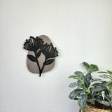 Alt text: "Minimalist wall art featuring a vibrant Pohutukawa Flower design, crafted from premium VCM material."