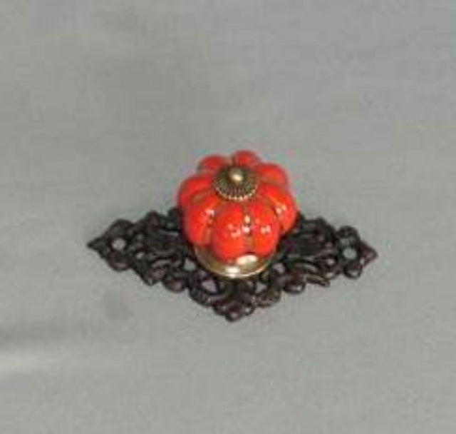 Red ceramic drawer knob with intricate detailing, perfect for enhancing home decor and adding color to cabinets and furniture.