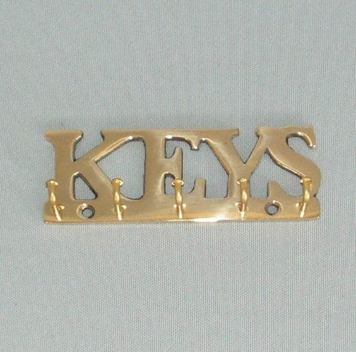 Elegant brass key rack with multiple hooks, perfectly combining style and functionality for organized entryways.