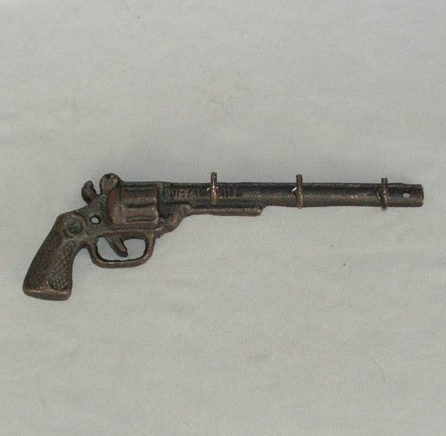 Solid cast iron key rack featuring a unique pistol design, perfect for stylish key organization in entryways.