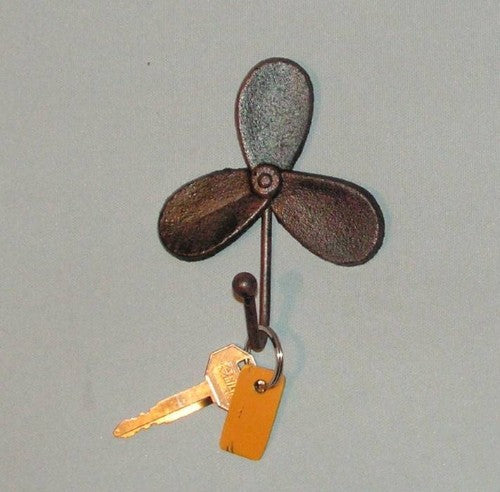 Nautical-themed cast iron key hook shaped like a propeller for stylish key organization and wall decor.