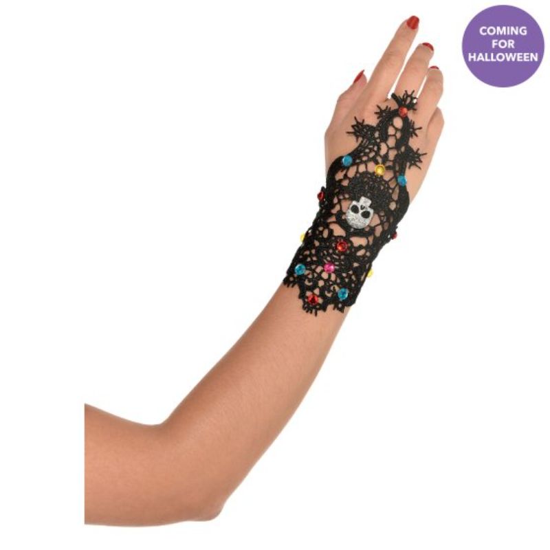 Colorful Day of the Dead hand bracelet with ring featuring intricate sugar skull designs, perfect for celebrating Dia de los Muertos.