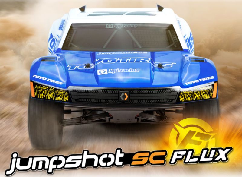 Alt text: "Flux 1/10 Jumpshot SC Toyo RC car with black 8-spoke wheels, showcasing robust design and off-road capabilities."