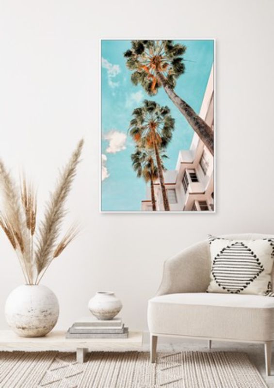 Framed canvas art featuring lush Miami palms against a bright blue sky, perfect for tropical-themed home decor.