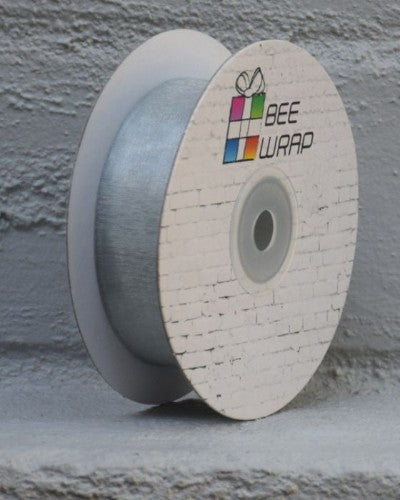 Soft silver cut edge organza ribbon, 25mm wide and 50m long, perfect for elegant gifts and decorations.