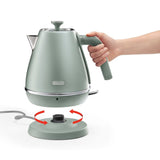 De'Longhi Distinta Perla Kettle in green, featuring a 1.7L capacity, 360° swivel base, and elegant pearlescent finish.