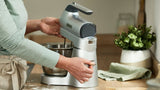 Stand & Hand Mixer in silver with 650W motor, variable speeds, splashguard, and ergonomic design for effortless mixing.