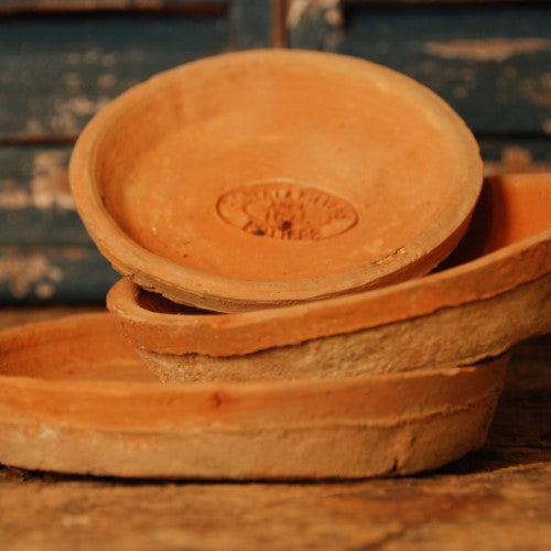 Handcrafted terracotta saucers measuring 14 x 14 x 2cm, ideal for catching excess water for indoor and outdoor plants.