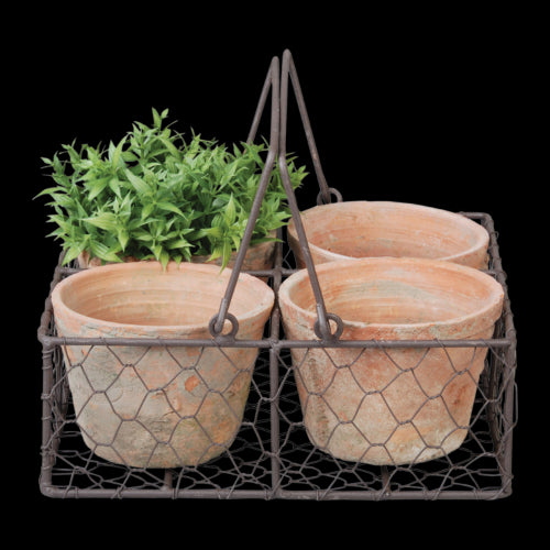 Rustic handcrafted terracotta pots in a wire basket with handle, perfect for indoor and outdoor plants.