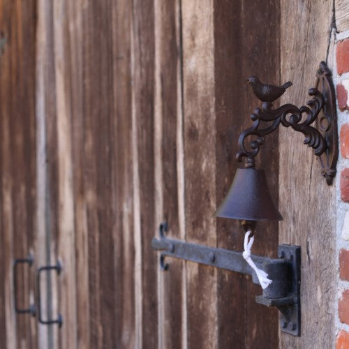 Rustic 24cm cast iron doorbell featuring a decorative bird design, perfect for welcoming guests with style.