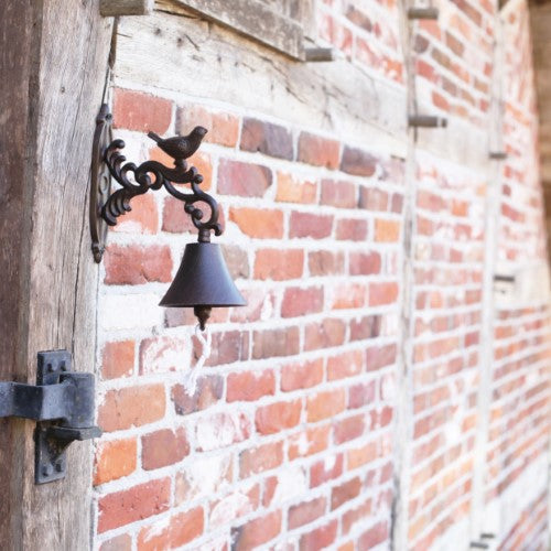 Rustic 24cm cast iron doorbell featuring a decorative bird design, perfect for welcoming guests with style.