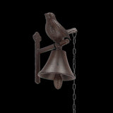 Rustic cast iron doorbell with bird design and chain pull, adds vintage charm to your entryway.