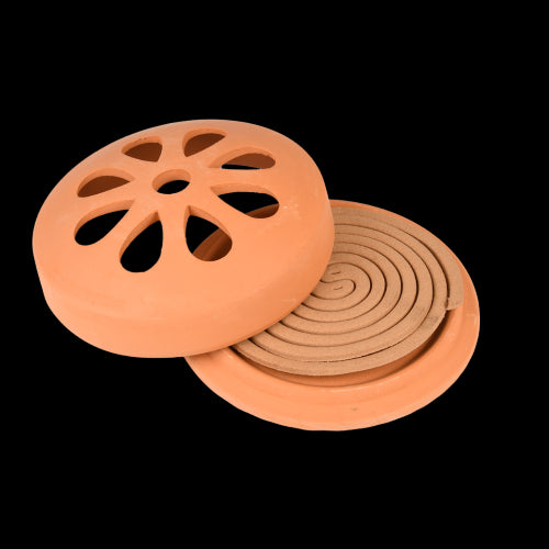 Citronella coils in a terracotta holder, designed to repel insects naturally for serene outdoor gatherings.