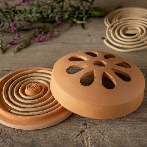 Citronella coils in a terracotta holder for outdoor insect repellent, measuring 15x15x6cm, perfect for summer evenings.