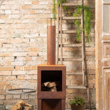 Rust-finish terrace heater with built-in wood storage, perfect for warmth and style in outdoor settings.